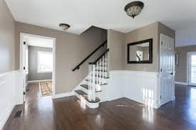 Freshly painted interior hallway with two-tone walls and white wainscoting