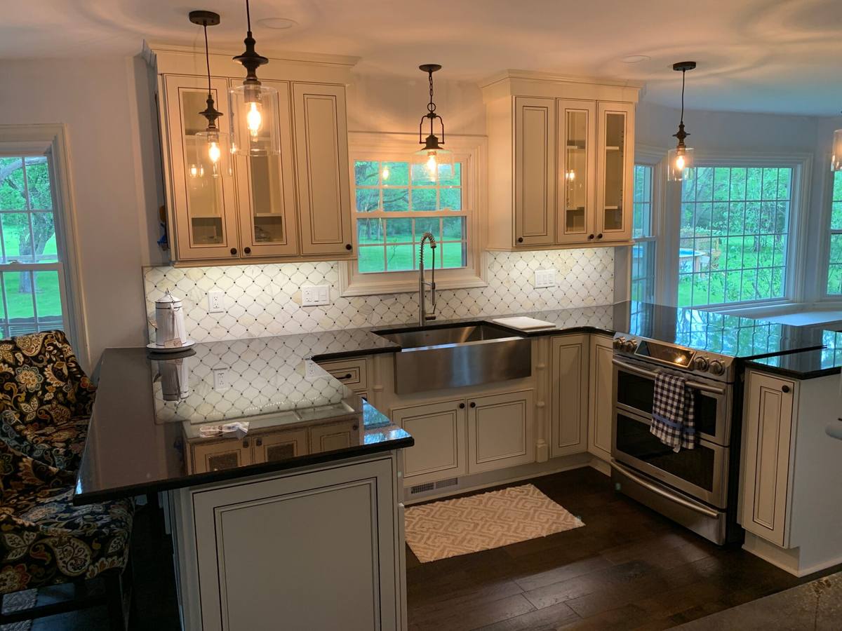 Compact remodeled kitchen with bright cabinetry and smart storage