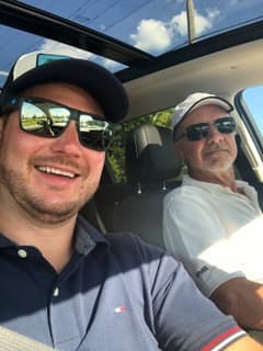 Father and son from the All American Remod family in the truck between jobs