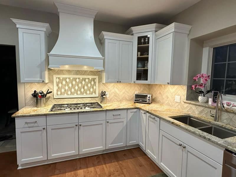 Kitchen with wood cabinetry and hardwood flooring