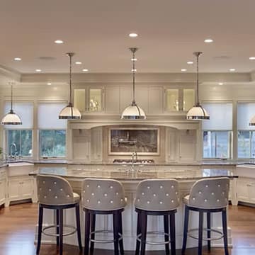 Custom kitchen remodel with white cabinetry, island and quartz countertops