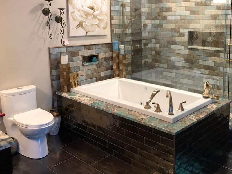 A tub and shower in a bathroom, fixtures of a luxury quality and feel